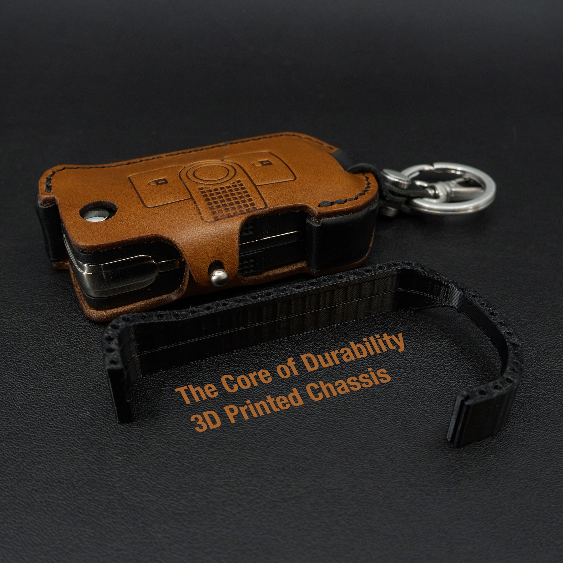 Brown leather keychain with 3D printed chassis on a black background