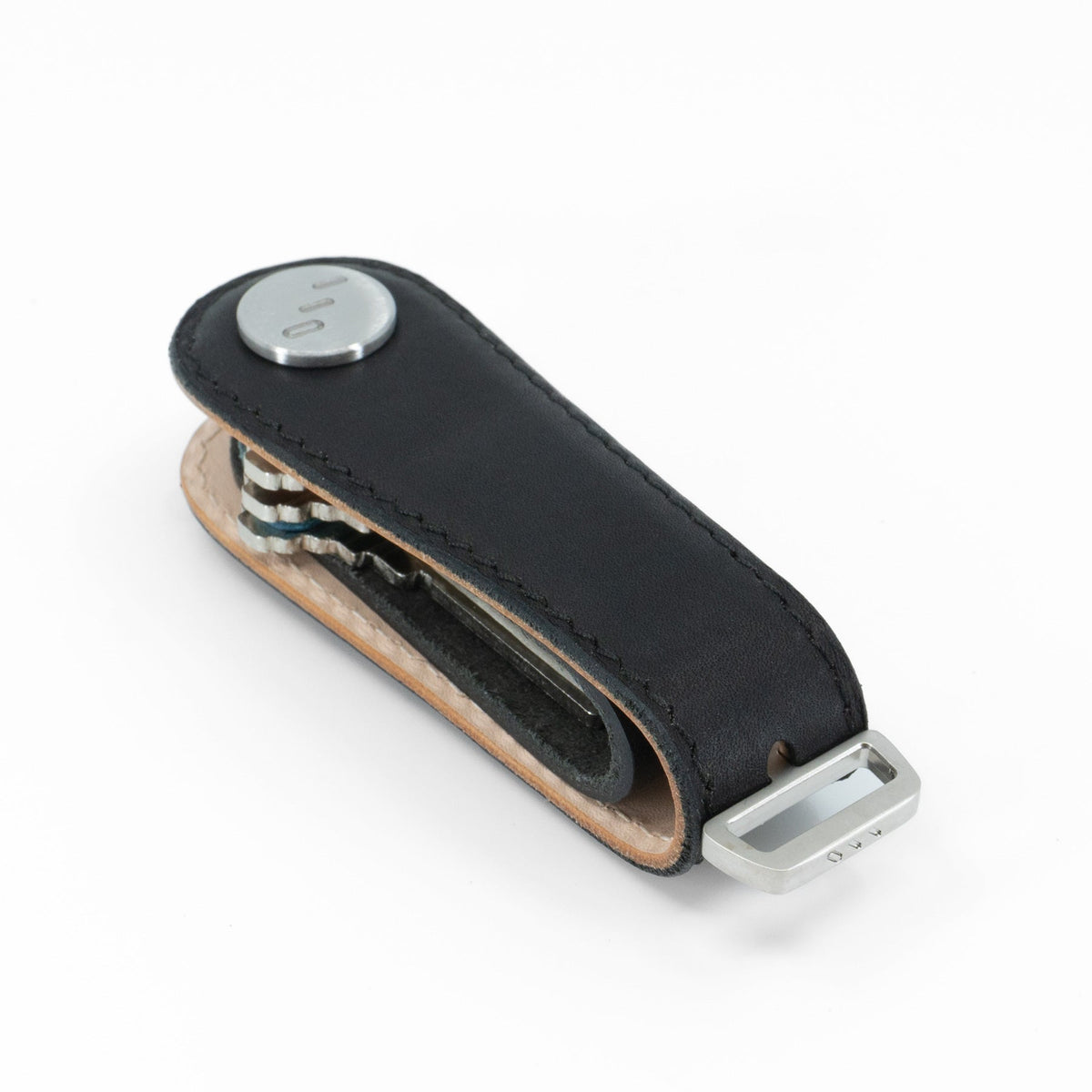 Black NOVONAPPA calfskin key organizer held in hand for size reference