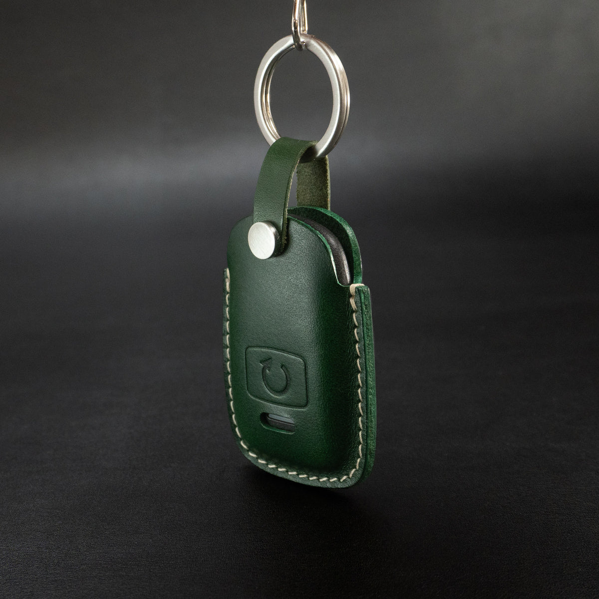 Subaru remote starter fob inserted into leather cover, showing fit
