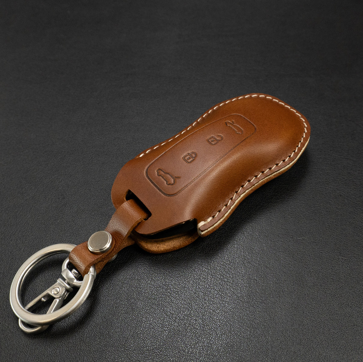 Porsche Macan EV key fob leather cover shown with car interior context