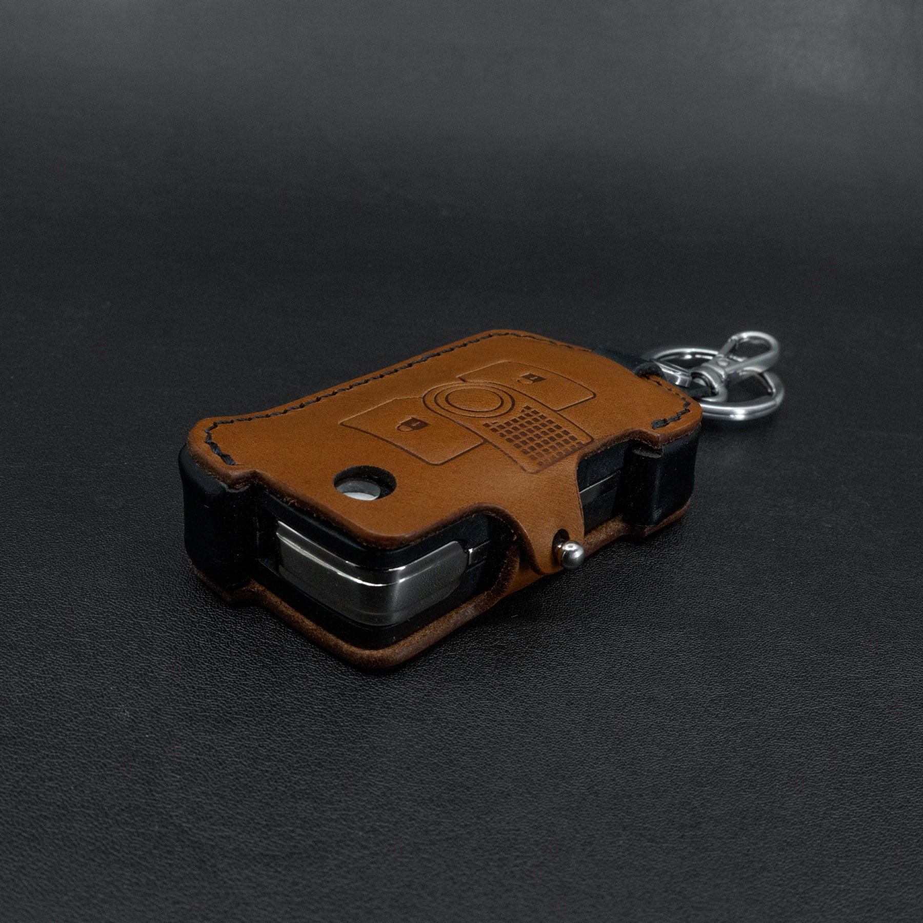 INEOS Grenadier leather key cover – brown body with black side accent detail