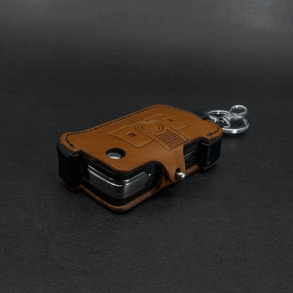 INEOS Grenadier leather key cover – brown body with black side accent detail