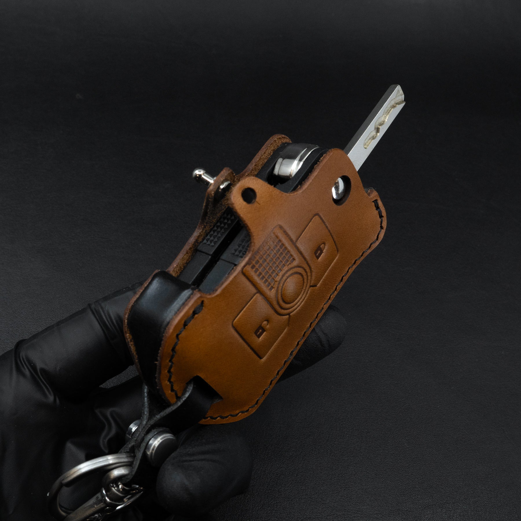 INEOS Grenadier leather key fob cover in brown and black – front view